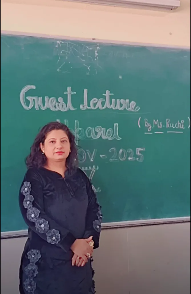 Woman standing in front of a classroom blackboard marked Guest lecture