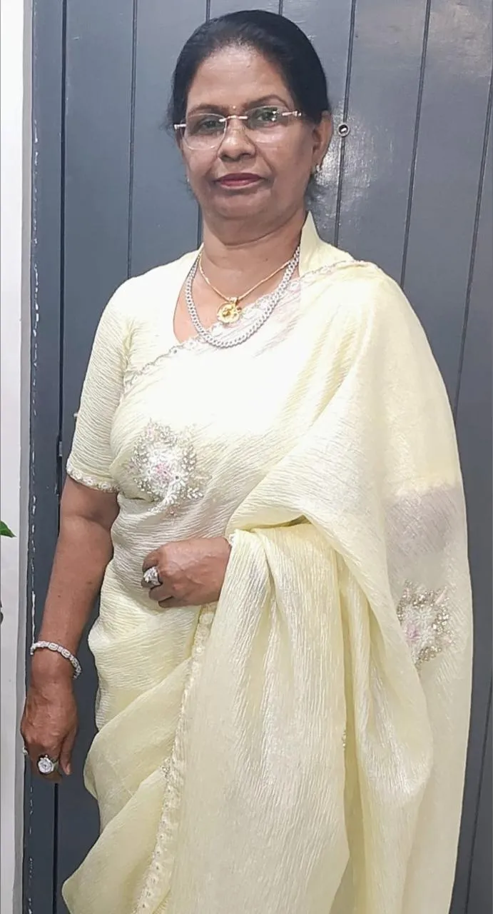Isha Rajan standing in a cream sari