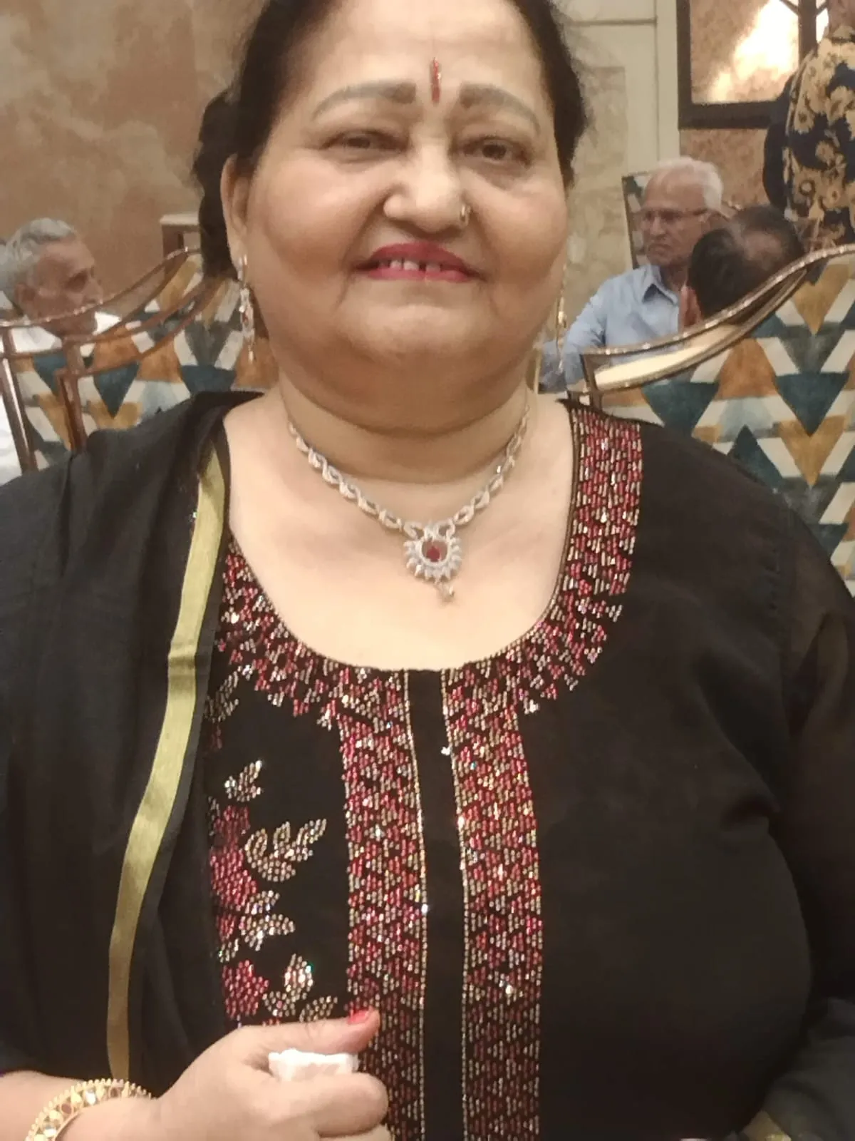 Renu Narula smiling at a community gathering