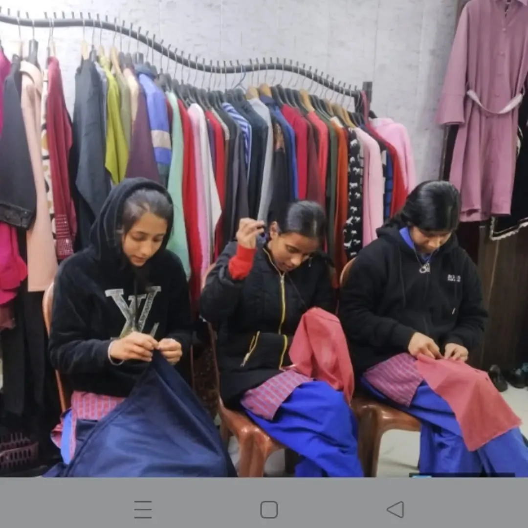 Students practising hand stitching during a Semarpan class
